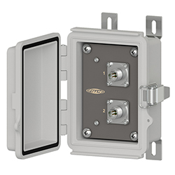 A grey polycarbonate, rectangular MX704 mini-maxx junction box with the front cover open to show 2 four-pin connectors in a column on a black panel with the CTC Line logo, steel mounting feet on the back, and a stainless steel snap latch on the right side.